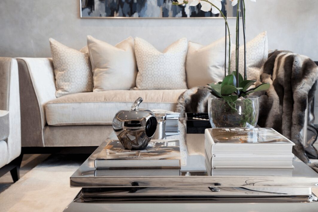 Luxurious styling with grand coffee table and cream sofa with feather cushions