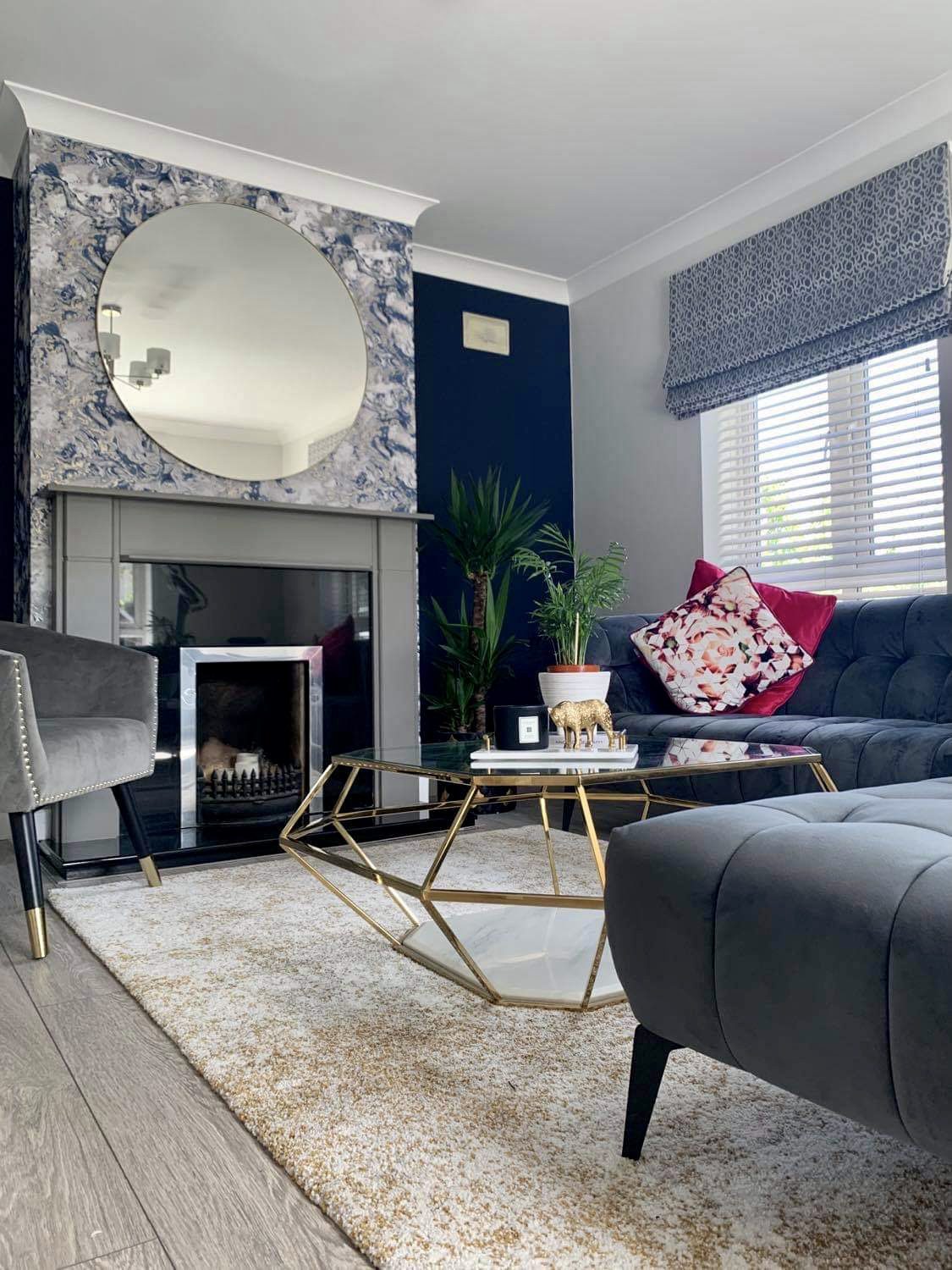 grey fireplace with round mirror above
