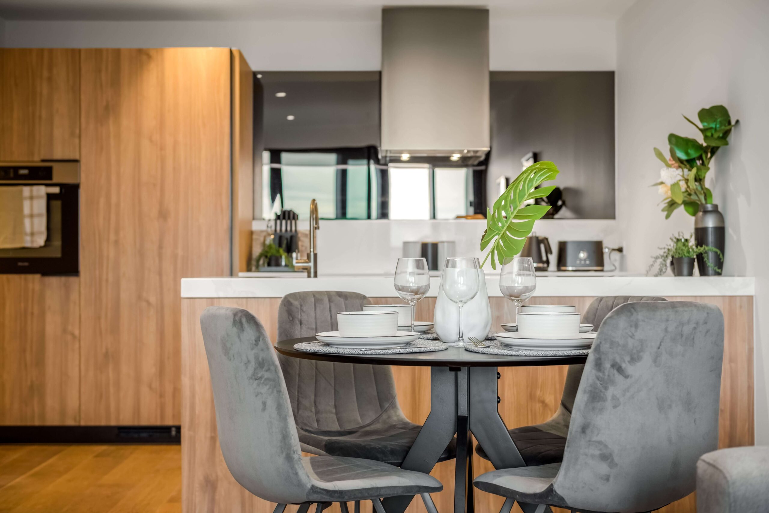 round black dining table with charcoal chairs