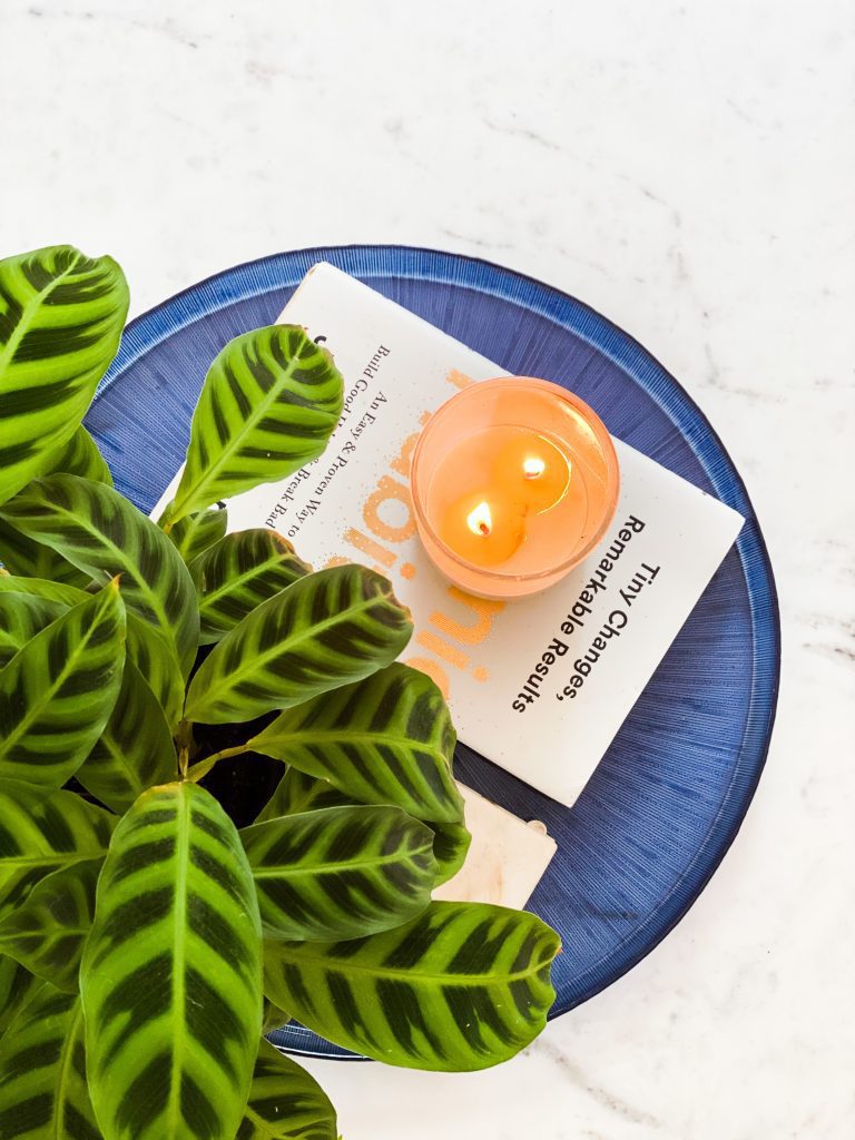 Burning candle on marble table