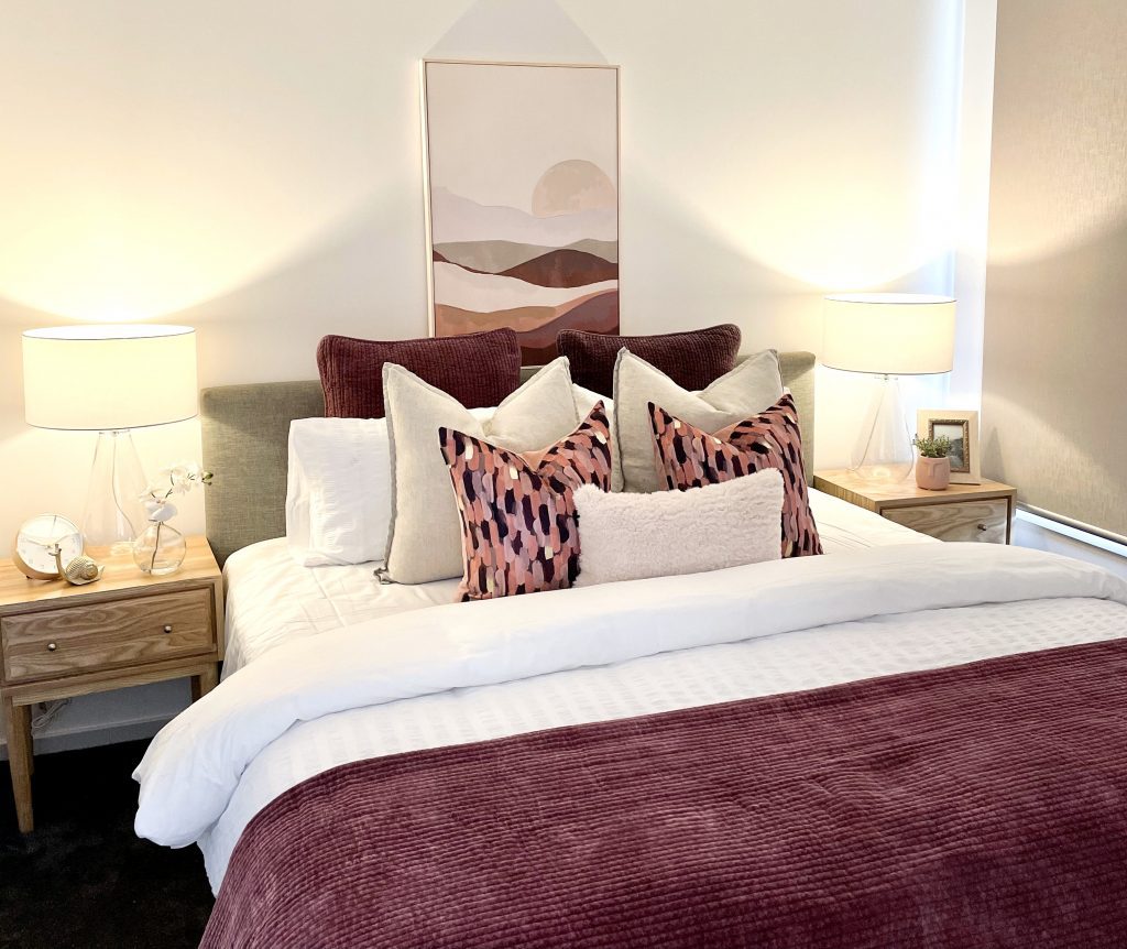 burgundy bedroom styling. moody bedroom. Cushion styling