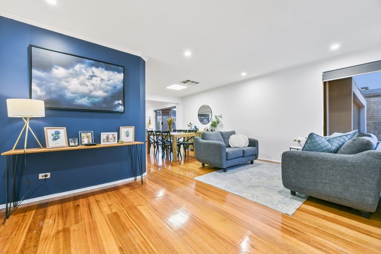 living room design with feature blue wall and cloud art
