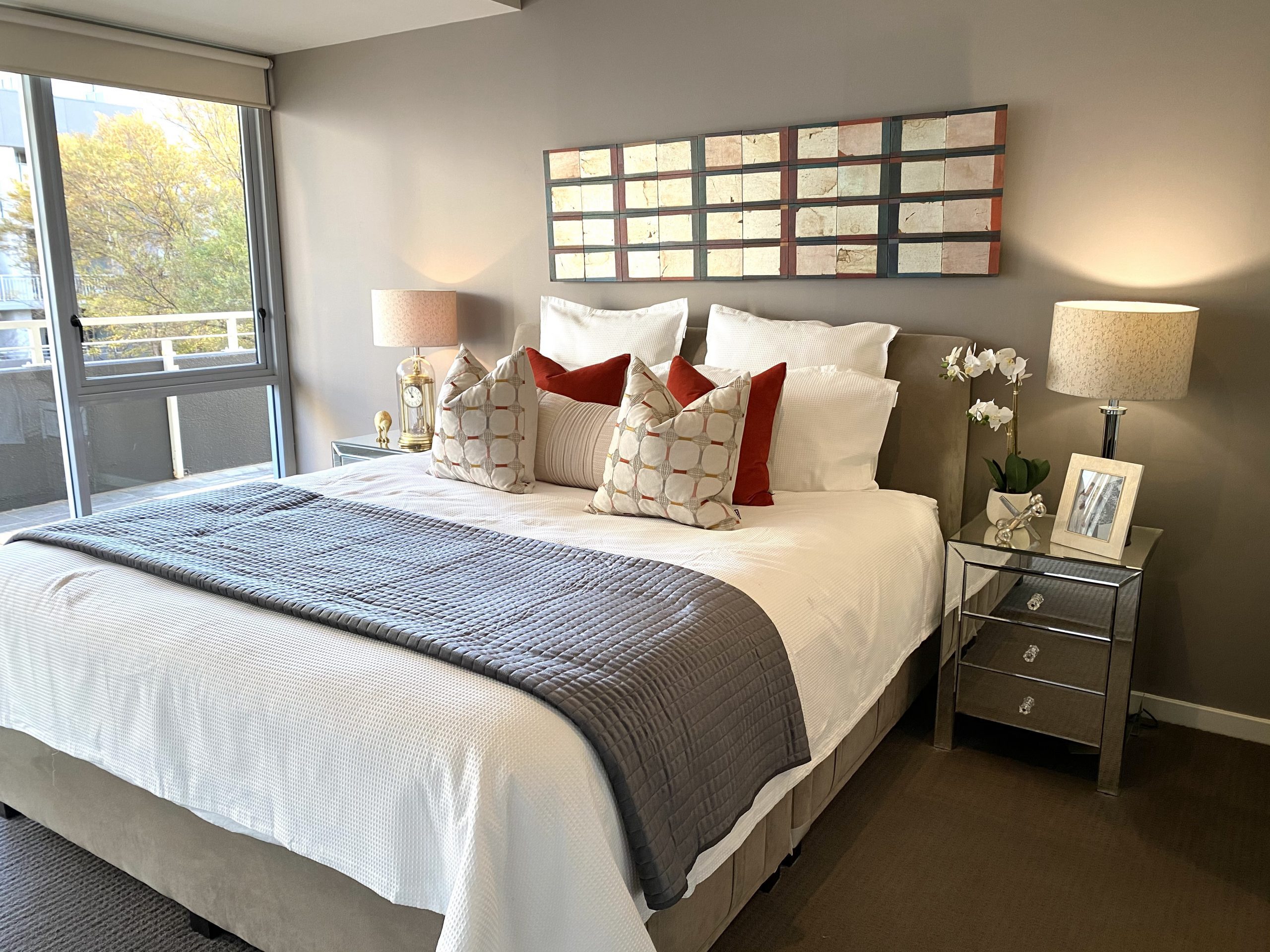master bedroom design with burnt orange and mirror bedsides