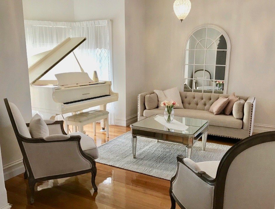 French Provincial living room with white grand piano