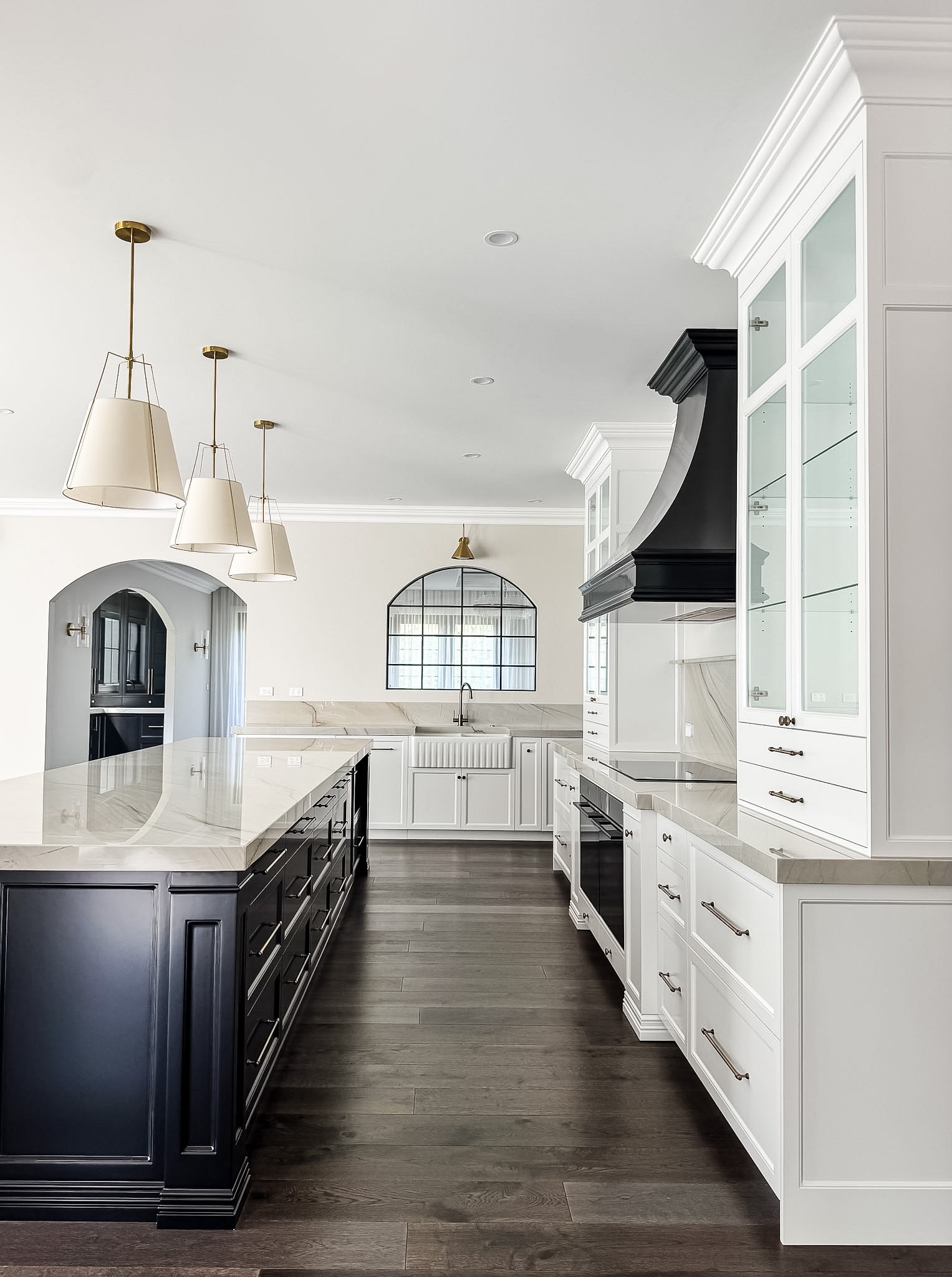 Black and white kitchen design with dark wood floor