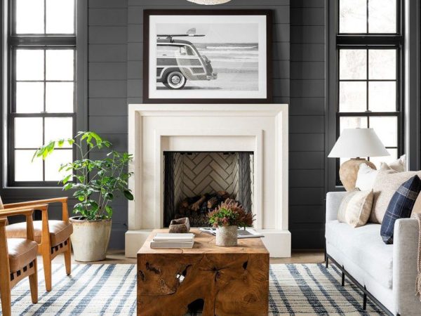 contemporary living room dark feature wall and white fireplace