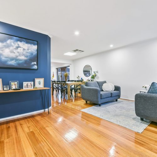 living room design with feature blue wall and cloud art