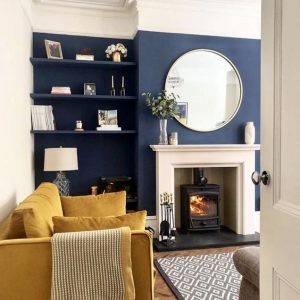 navy blue wall with mustard sofa