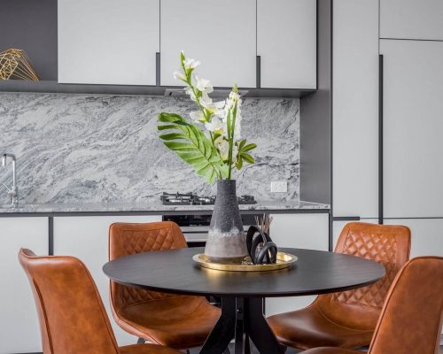 kitchen styling round black dining table with tan leather dining chairs