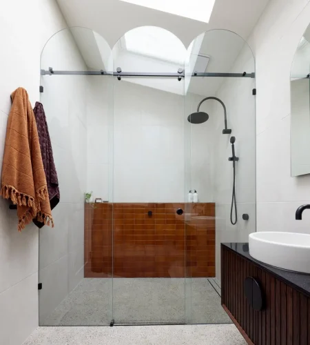 brown bathroom tiles with dark wood vanity