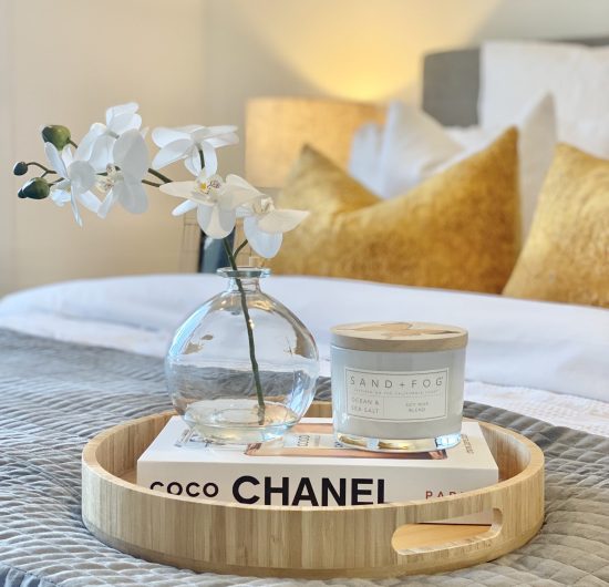decorative tray on a bed for styling
